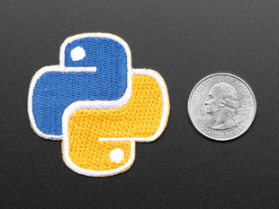 Rounded cross shaped embroidered badge of the yellow and blue Python Foundation logo. Next to a quarter for scale.