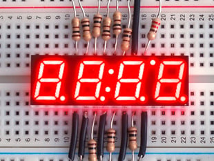 Small red 7-segment clock display with all segments lit