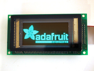 128x64 Graphic Vacuum Fluorescent Display showing Adafruit logo