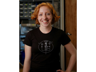 Women wearing black t-shirt with white NPN transistor diagram with a man inside the diagram