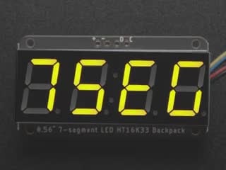 Yellow 7-segment clock display soldered to backpack with all segments lit