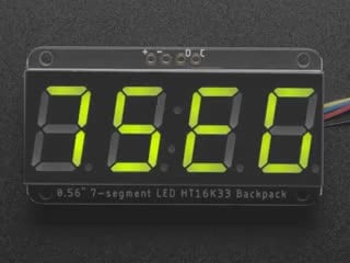 Green 7-segment clock display soldered to backpack with all segments lit