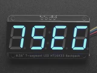 Blue 7-segment clock display soldered to backpack with all segments lit