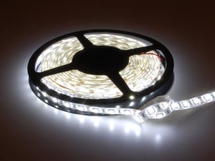 Spool of flexible LED strip lit up cool white