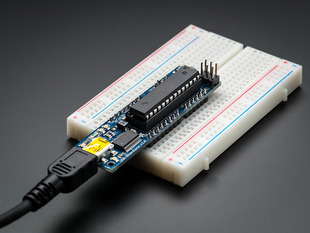 Angled shot of a USB Boarduino (Arduino compatible) Kit w/ATmega328 connected to a white breadboard.