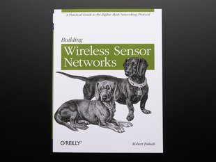 Front cover of "Building Wireless Sensor Networks" by Rob Faludi. Cover features a black-and-white illustration of two collared Dachshunds. 
