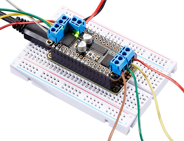 Top view of a DC Motor and Stepper FeatherWing plugged into a white breadboard.