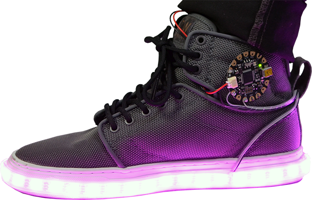 Side view of a shoe with an Adafruit FLORA board attached and LED light strip around the bottom glowing purple