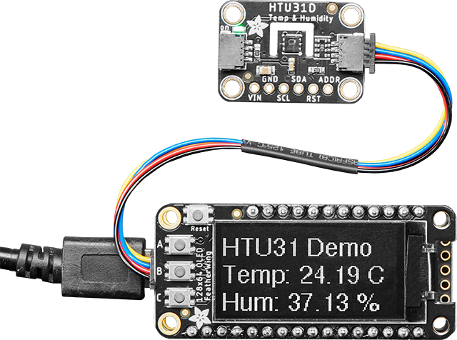 HTU31D Temperature and Humidity board connected to an OLED FeatherWing  with STEMMA cable showing the temperature and humidity readings.